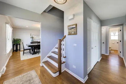 a view of entryway and hall with wooden floor