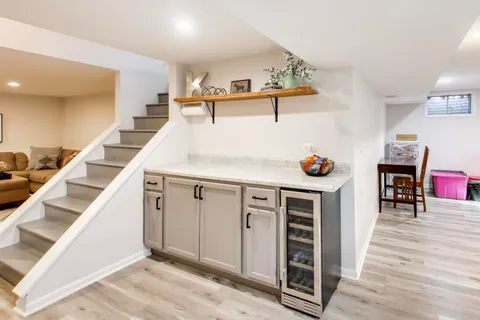 a kitchen with stainless steel appliances cabinets and wooden floor