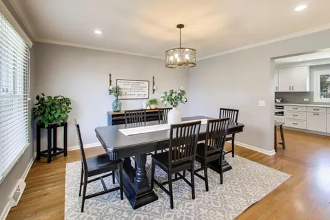 a view of a dining room with furniture wooden floor and chandelier