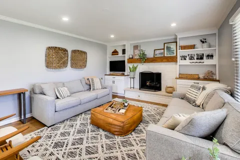 a living room with furniture and a fireplace