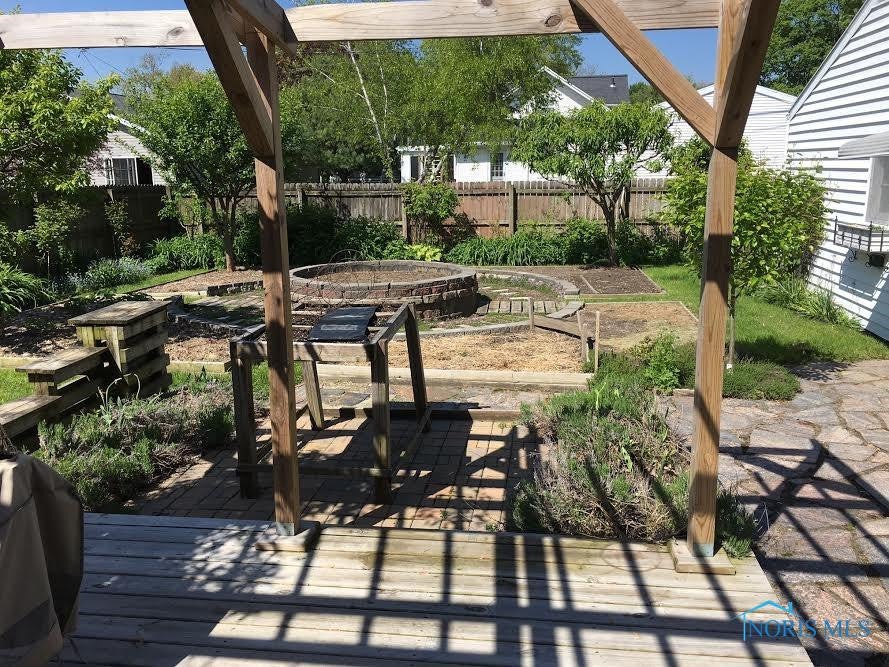 711 Ransom Street Maumee, OH 43537 - Photo 16 of 17 Sit on this great deck and watch your garden grow! There are raised beds, fruit trees and lots to discover.Could be converted back to grass for those that do not have a green thumb!