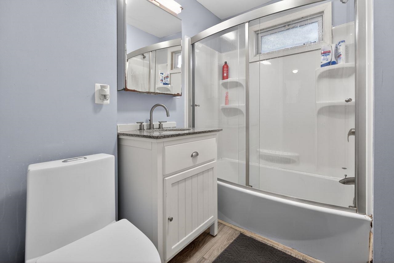 229 Patterson Street Harrison, NJ 07029 - Photo 5 of 26 a bathroom with a granite countertop sink toilet and shower