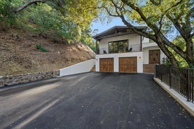 a view of a house with a tree in front