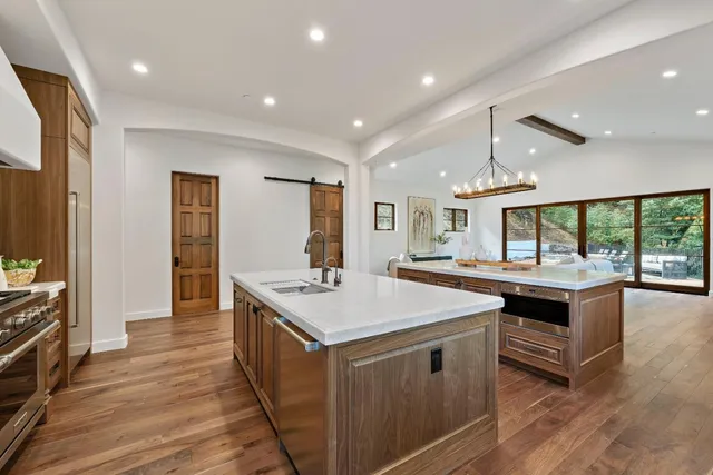a view of a patio with couches table and chairs and potted plants