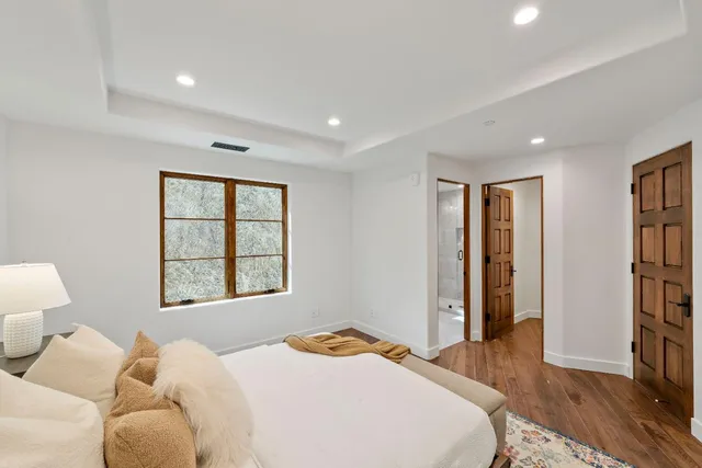 a bedroom with a bed and a large window