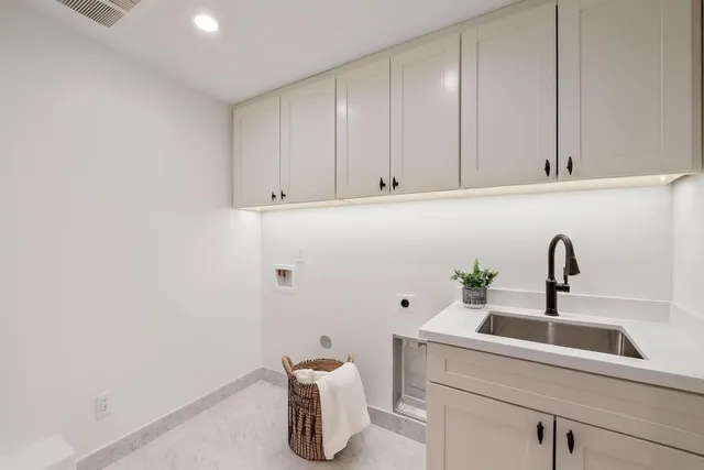 a bathroom with double vanity and a mirror
