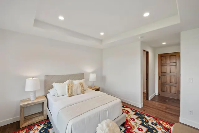 a bathroom with a double vanity sink a large mirror and shower
