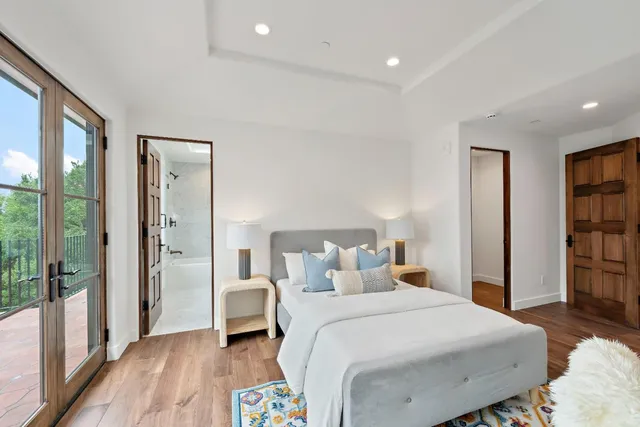 a bedroom with a large bed and a large window