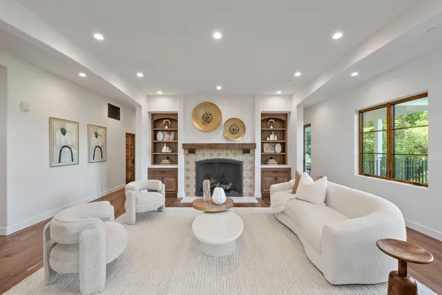 a living room with furniture and a fireplace
