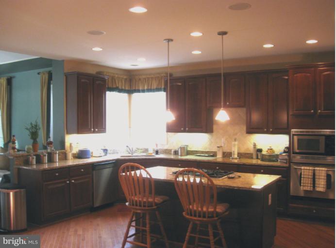 10803 Catron Road Perry Hall, MD 21128 - Photo 22 of 30 a kitchen with a table chairs sink and cabinets