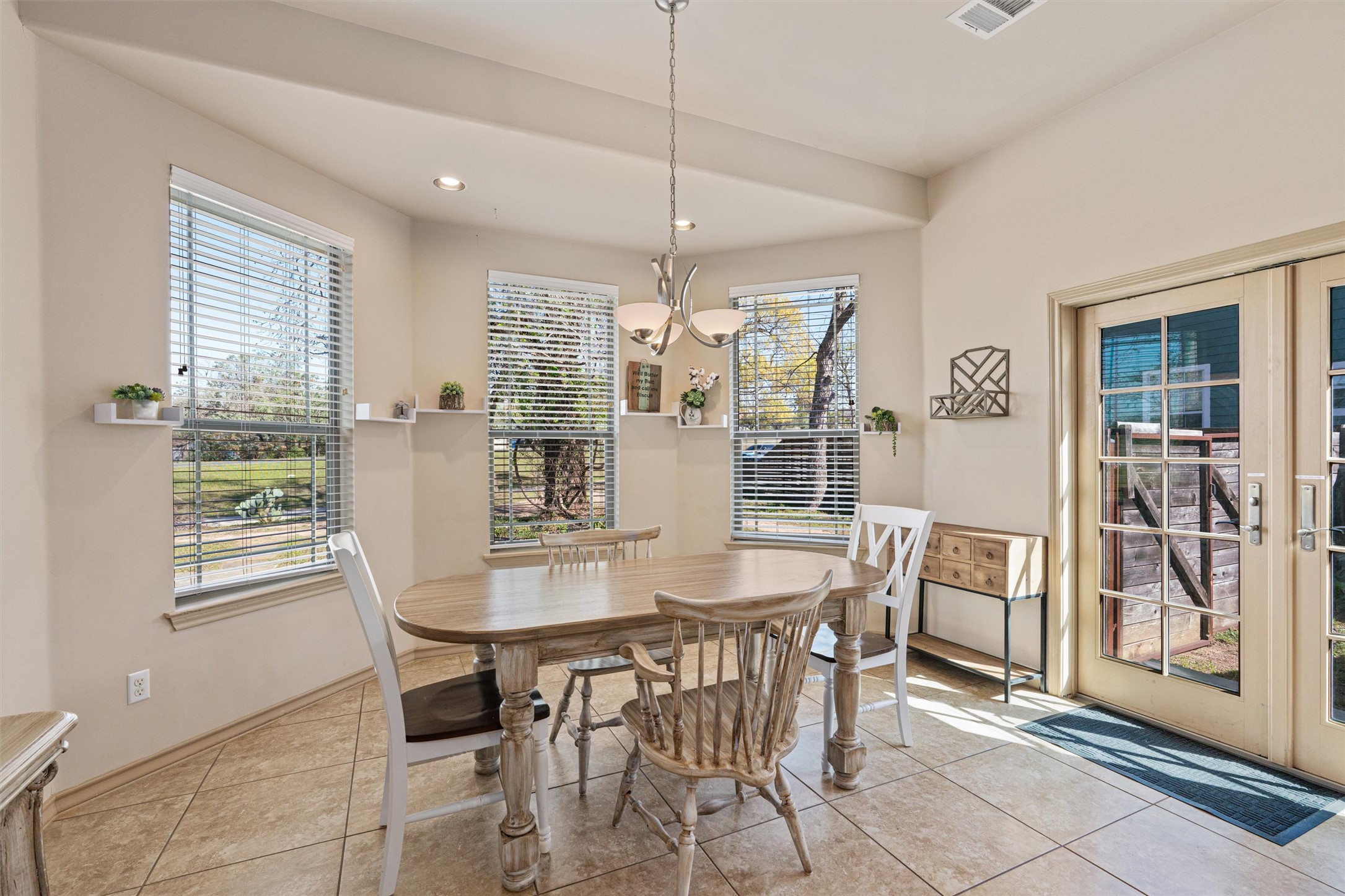 209 Harris Street Elgin, TX 78621 - Photo 11 of 40 Dining room with french doors, light tile patterned floors, and a chandelier