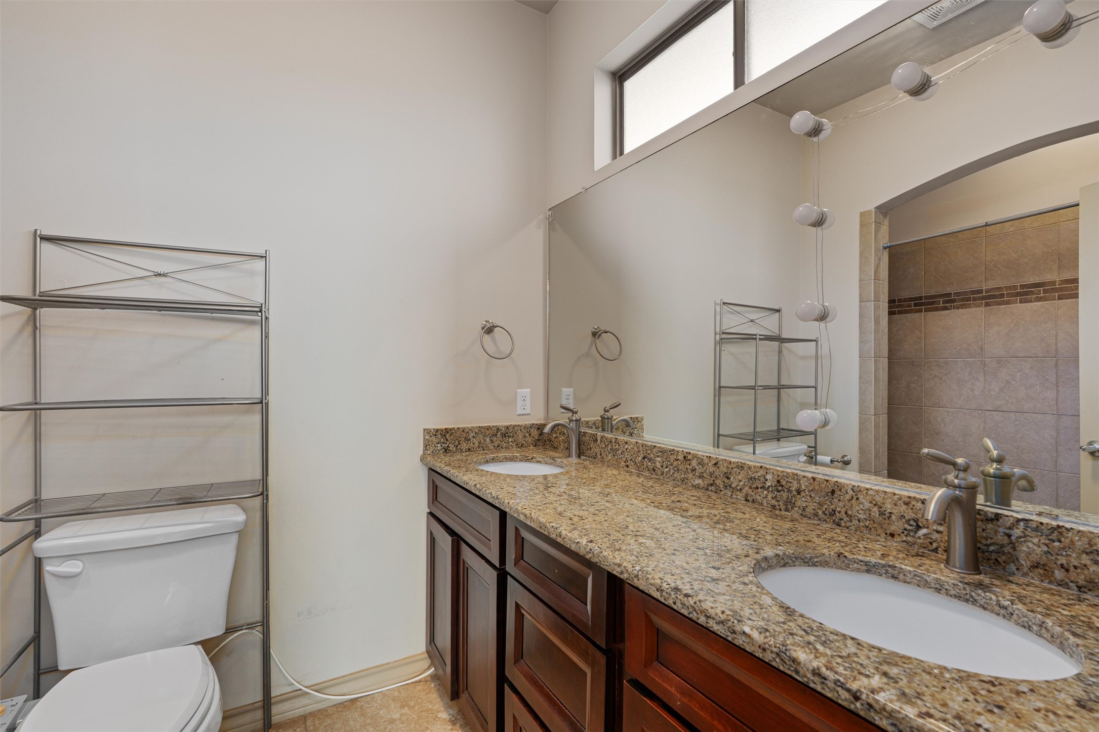 209 Harris Street Elgin, TX 78621 - Photo 14 of 40 Bathroom with double vanity and tiled shower