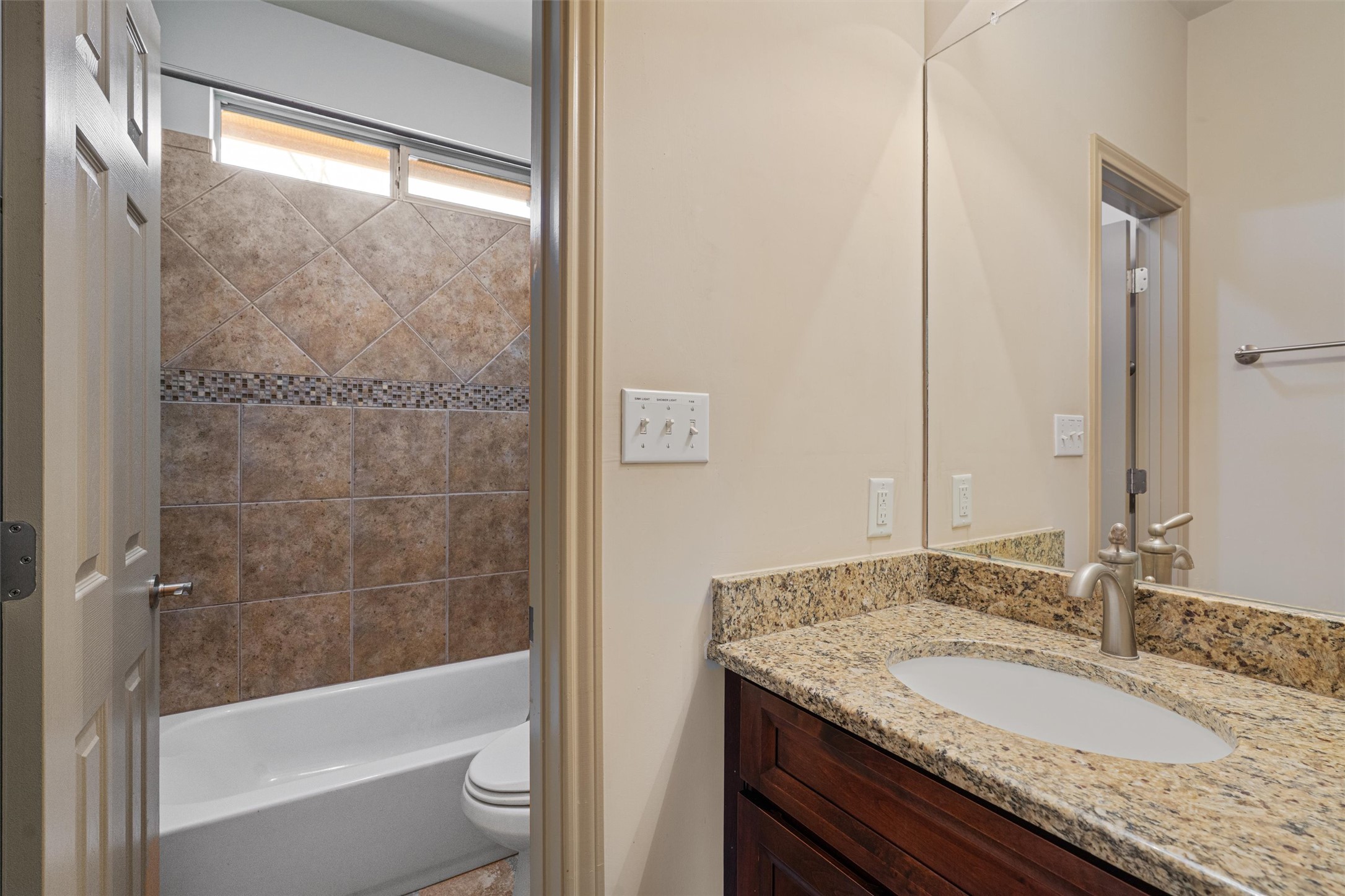 209 Harris Street Elgin, TX 78621 - Photo 17 of 40 Full bath featuring vanity and shower combination