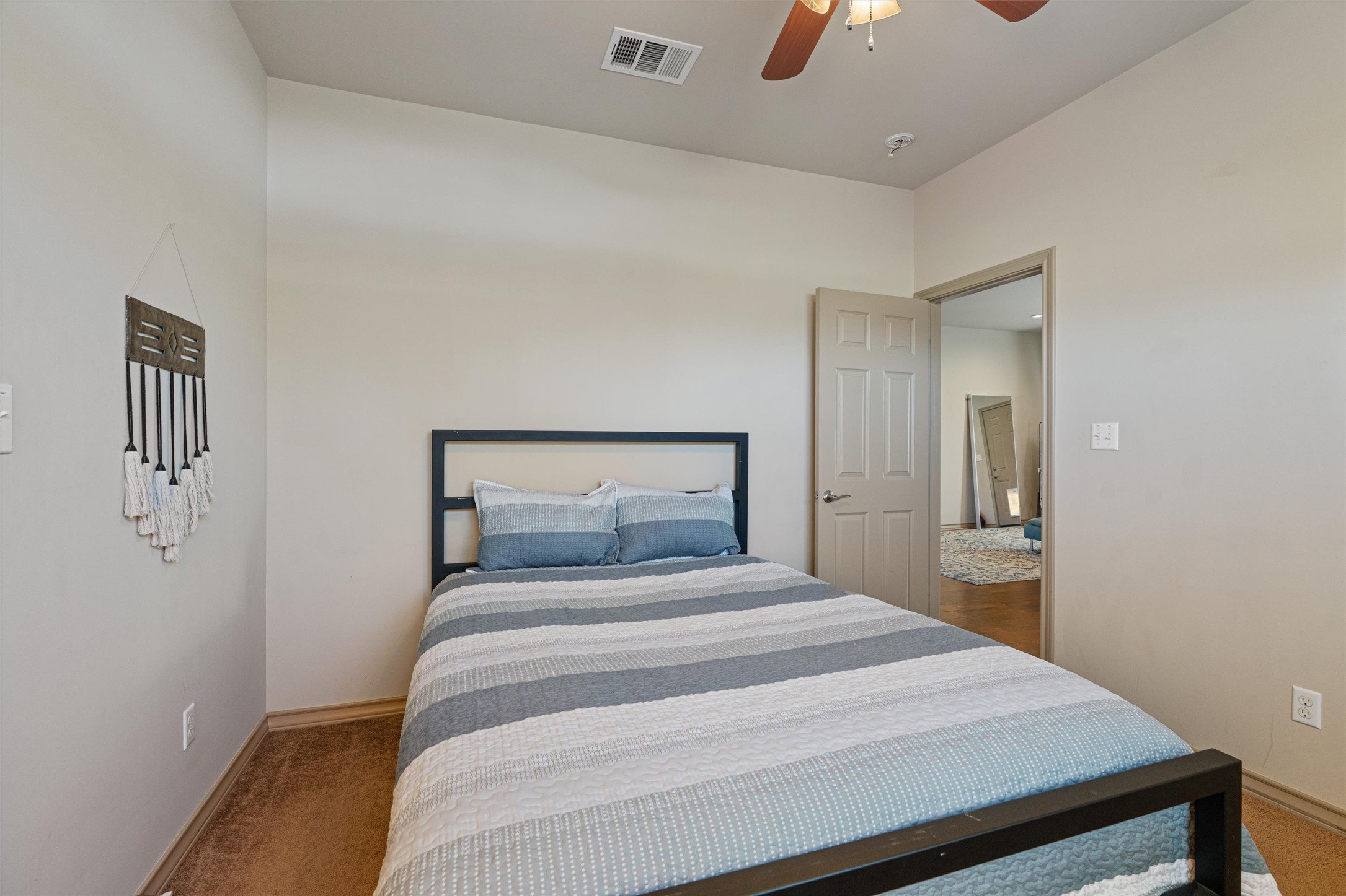 209 Harris Street Elgin, TX 78621 - Photo 21 of 40 Bedroom with light colored carpet and ceiling fan