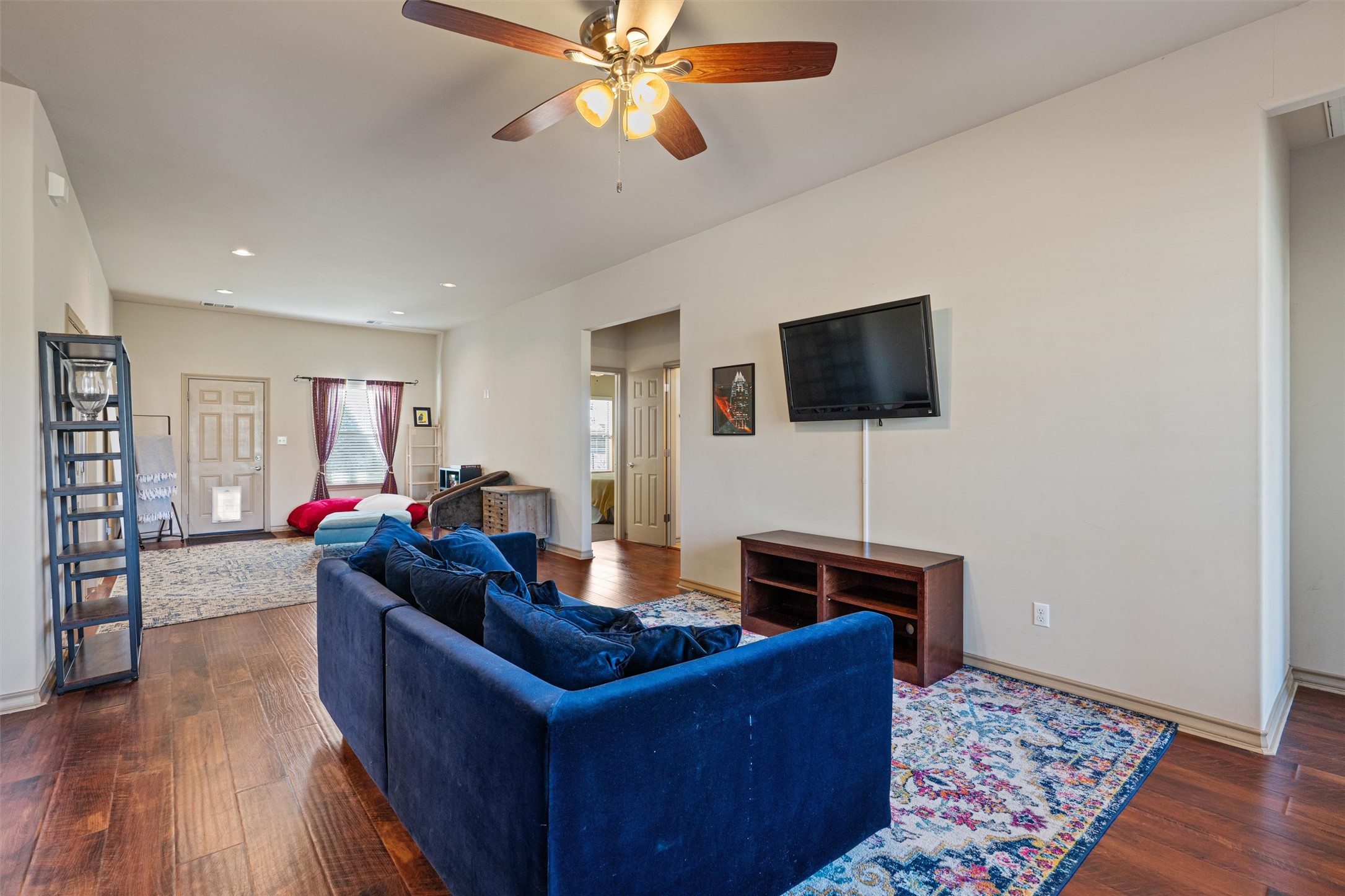 209 Harris Street Elgin, TX 78621 - Photo 3 of 40 Living room featuring dark wood-type flooring, ceiling fan, and recessed lighting