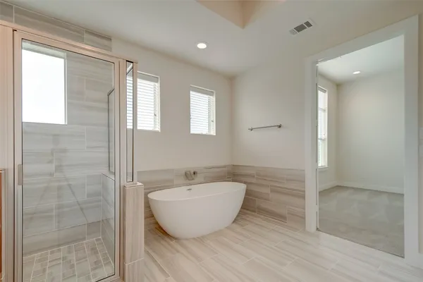 a view of a bathroom with a bathtub and shower