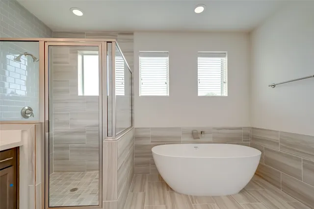 a bathroom with a bathtub and shower