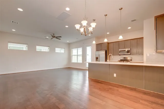 a view of a kitchen and kitchen with a dishwasher cabinets