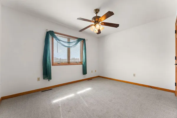 an empty room with windows and air conditioner