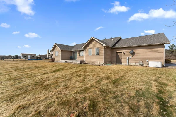 a view of a large pool with an outdoor space and seating area