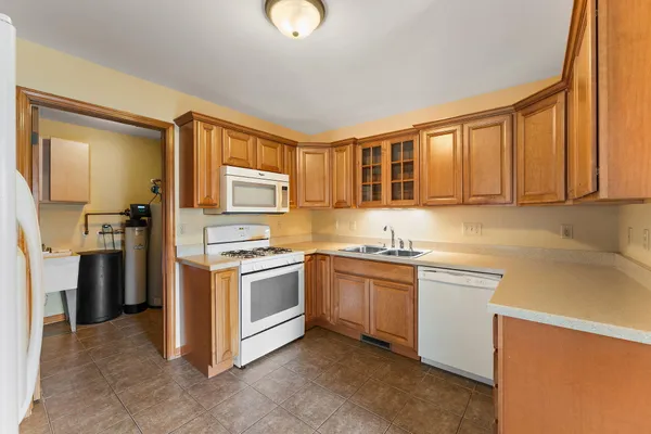 a kitchen with stainless steel appliances granite countertop a stove sink and refrigerator