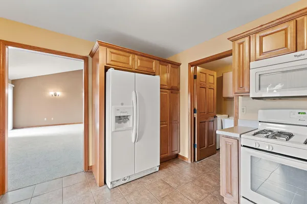 a kitchen with stainless steel appliances granite countertop a refrigerator and a stove top oven