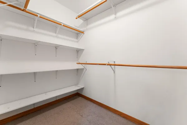 a spacious bathroom with a toilet a sink and a mirror