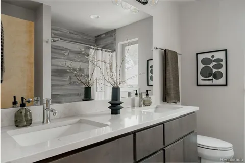 a bathroom with a sink and a large mirror