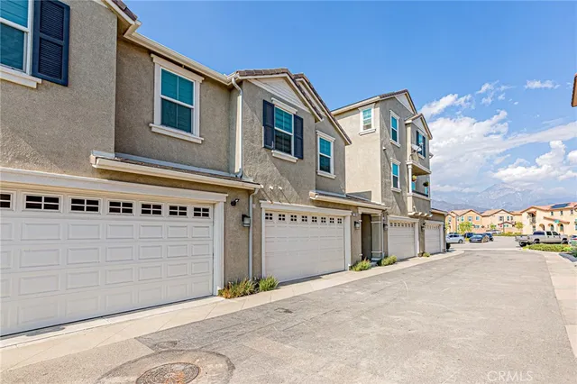 a front view of a building with parking area
