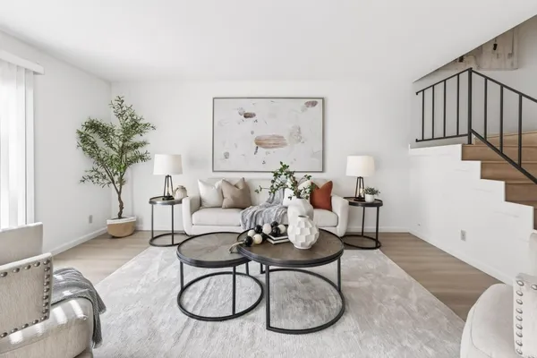 a living room with furniture and a potted plant