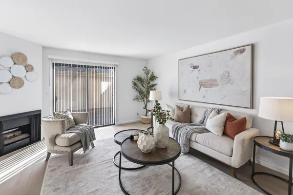 a living room with furniture and a potted plant