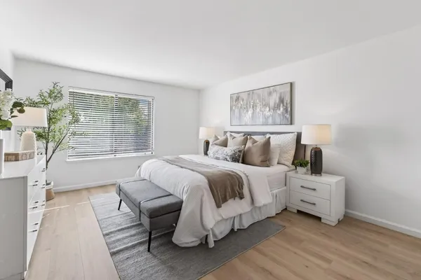 a bedroom with a bed and a large window