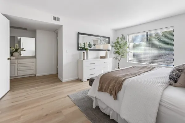 a bedroom with a bed and a dresser