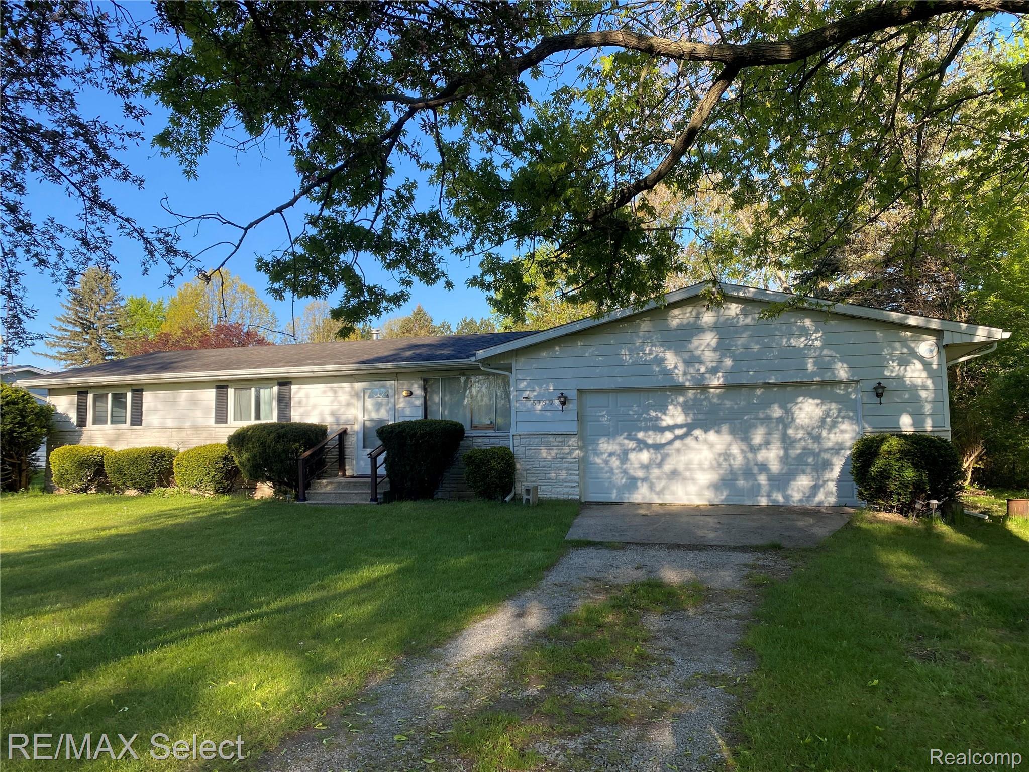 6169 Johnson Road Flushing, MI 48433 - Photo 24 of 28 Ranch-style home featuring driveway, a front yard, and a garage