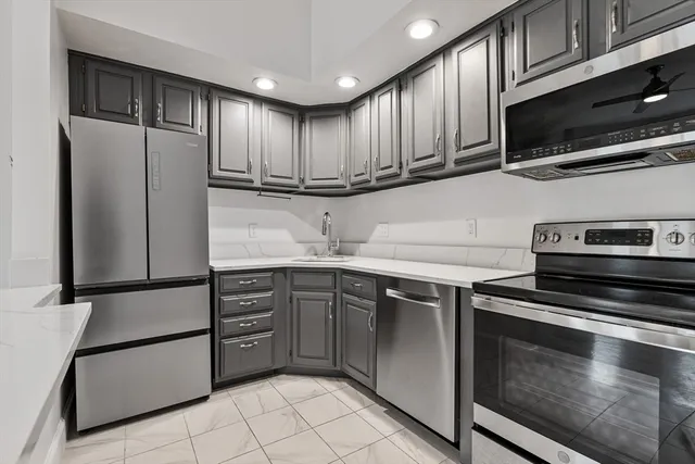 a kitchen with stainless steel appliances granite countertop a refrigerator sink and cabinets