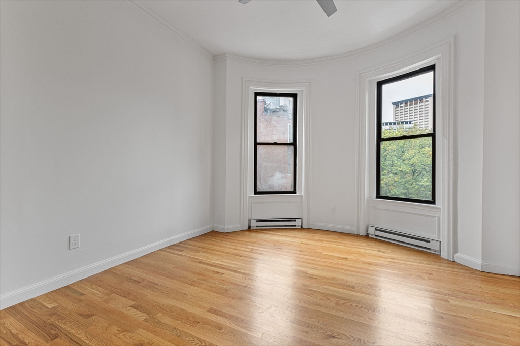431 Columbus Avenue, Unit 4 Boston, MA 02116 - Photo 14 of 27 a view of an empty room with window and wooden floor