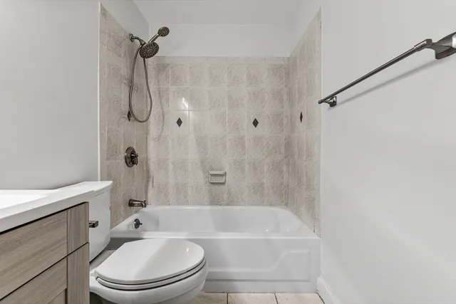 a bathroom with a bathtub toilet and shower