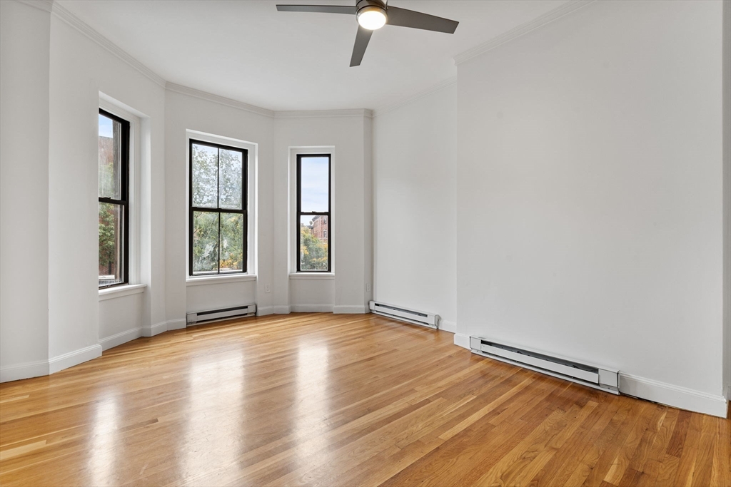 431 Columbus Avenue, Unit 4 Boston, MA 02116 - Photo 3 of 27 a view of an empty room with window and wooden floor
