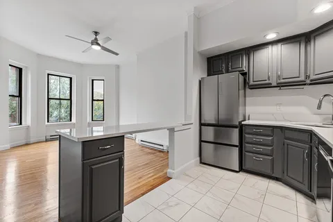 a kitchen with stainless steel appliances granite countertop a refrigerator and a sink