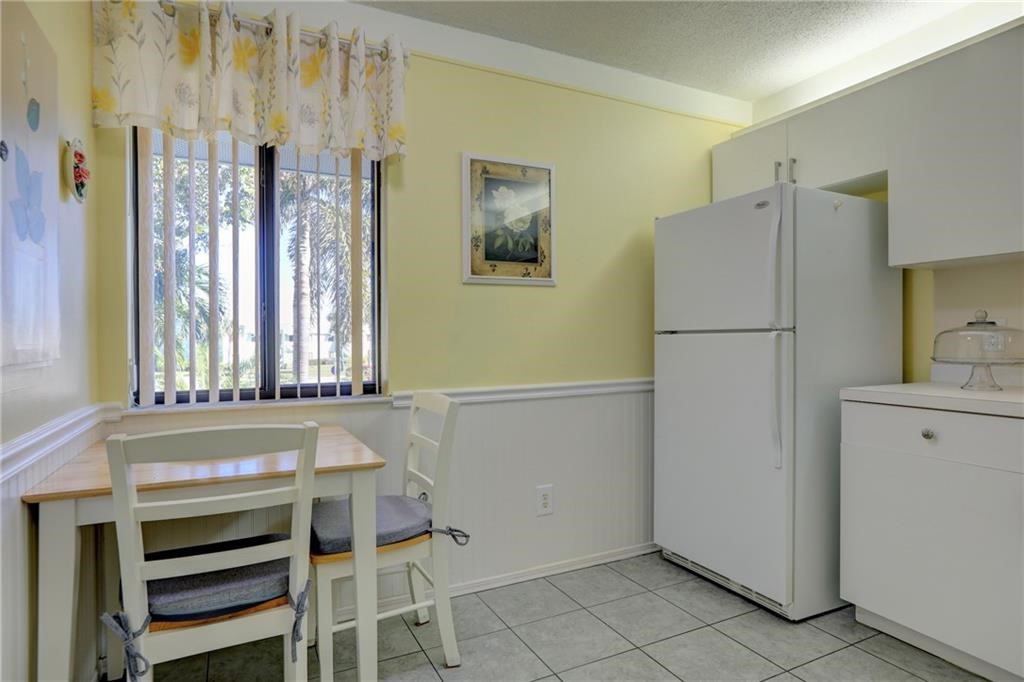 9635 Riverside Drive, Unit 4 Sebastian, FL 32958 - Photo 18 of 36 a kitchen with a refrigerator and countertop