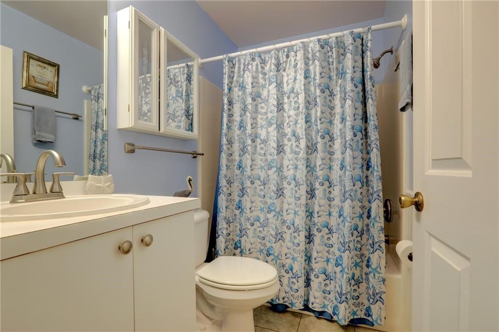 9635 Riverside Drive, Unit 4 Sebastian, FL 32958 - Photo 25 of 36 a bathroom with a sink toilet and shower
