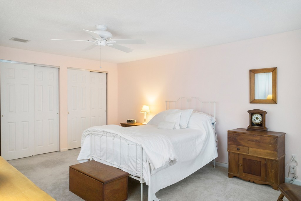 82 Meeting House Path, Unit 82 Ashland, MA 01721 - Photo 13 of 23 a bedroom with a bed and a dresser
