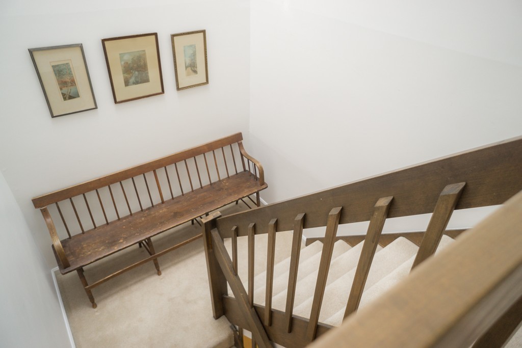 82 Meeting House Path, Unit 82 Ashland, MA 01721 - Photo 17 of 23 a view of staircase with lots of frames on wall