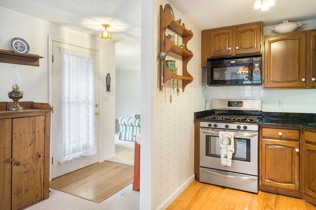 82 Meeting House Path, Unit 82 Ashland, MA 01721 - Photo 2 of 23 a kitchen with stainless steel appliances granite countertop a stove a refrigerator and a microwave
