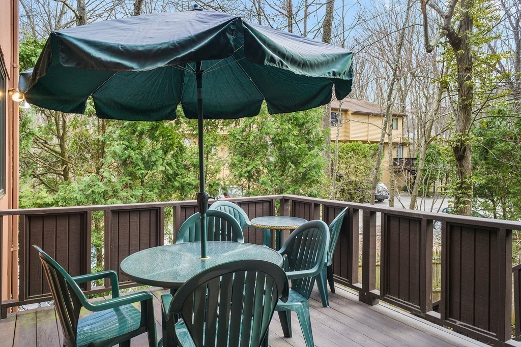 82 Meeting House Path, Unit 82 Ashland, MA 01721 - Photo 21 of 23 a view of deck with furniture and barbeque grill with wooden fence