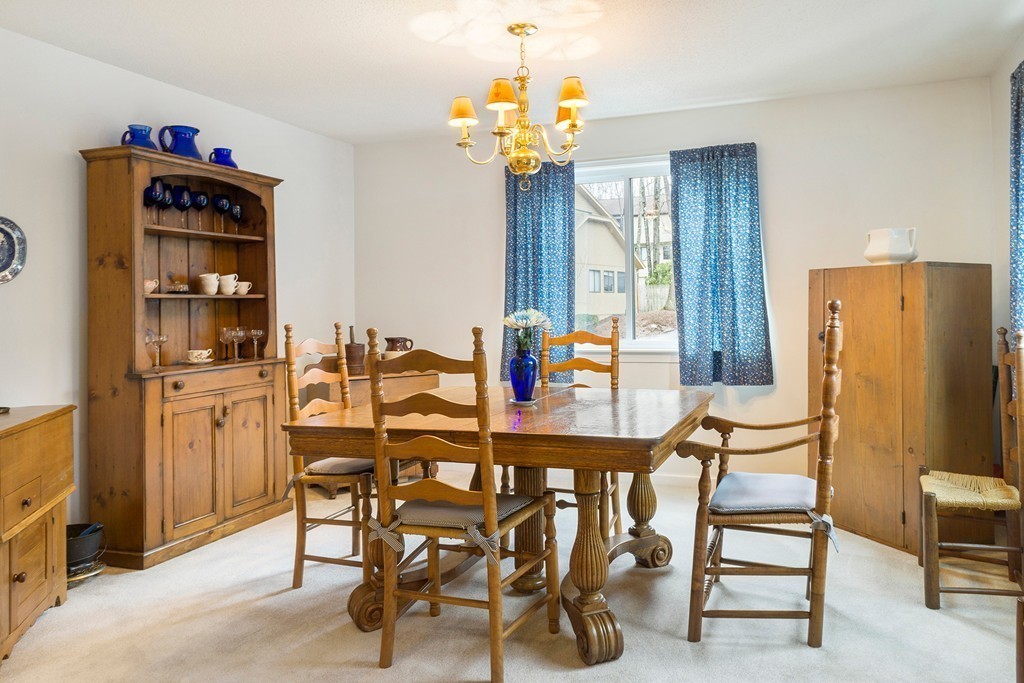 82 Meeting House Path, Unit 82 Ashland, MA 01721 - Photo 5 of 23 a dining room with furniture and chandelier