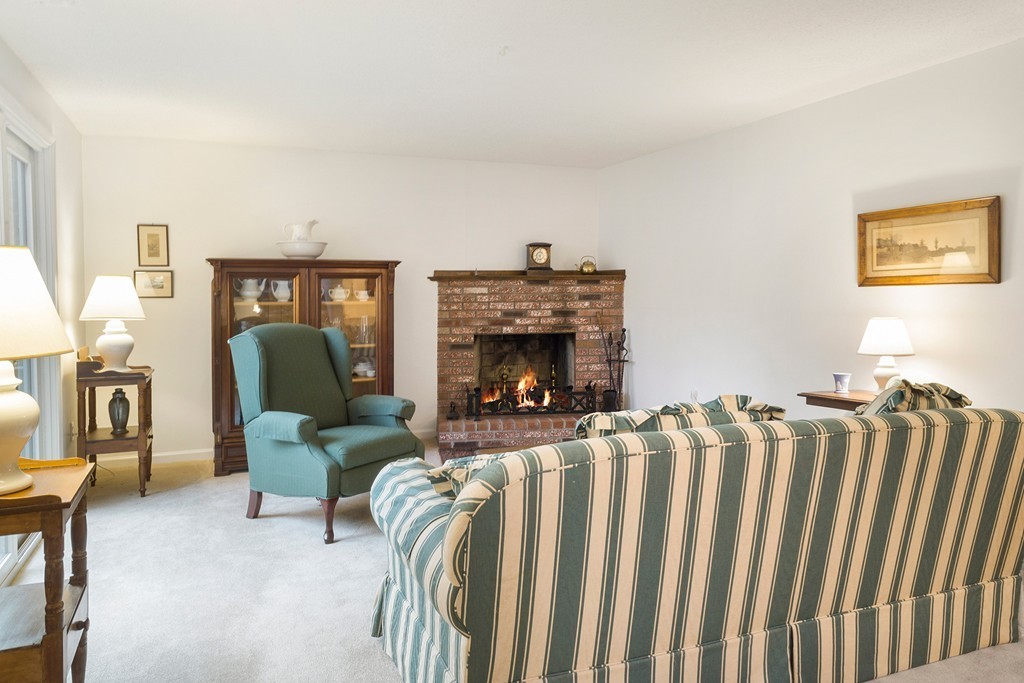 82 Meeting House Path, Unit 82 Ashland, MA 01721 - Photo 7 of 23 a living room with furniture a fireplace and a piano