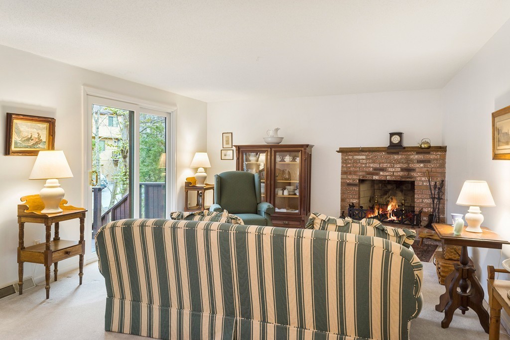 82 Meeting House Path, Unit 82 Ashland, MA 01721 - Photo 8 of 23 a living room with furniture a fireplace and dining table