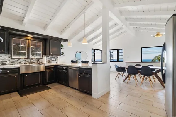 a large kitchen with lots of counter and chairs