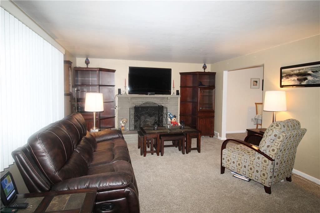 316 Byron Road Pittsburgh, PA 15237 - Photo 4 of 14 Living Room-stone fireplace-wall to wall carpeting.